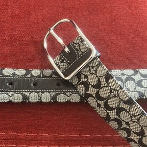 Petite Coach Women’s black belt with coach print and polished silver buckle.